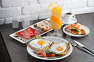 A set of products for a delicious European Breakfast Scrambled eggs, croissants and orange juice