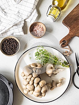 Set of products and kitchen utensils for cooking fried oyster mushrooms with thyme. Top view