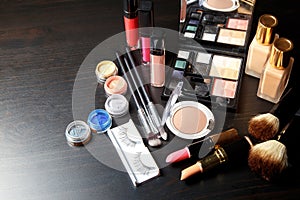 Set professional cosmetics on dark background with copy space