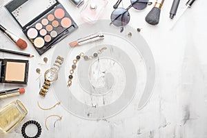 Set of professional cosmetics, makeup tools and accessories on a white marble background with copy space for text. concept of
