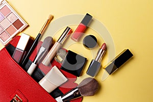 Set of professional elite decorative cosmetics for makeup on a yellow background. The concept of beauty and fashion