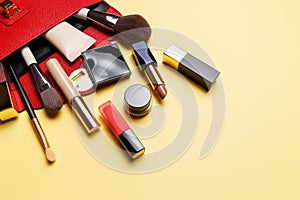 Set of professional elite decorative cosmetics for makeup on a yellow background. The concept of beauty and fashion