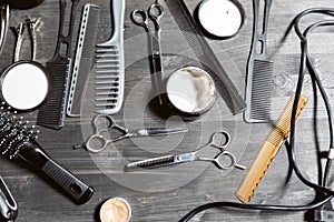 Set of professional hairdresser tools on grey background. Wooden table in barbershop. Working tool of barber master