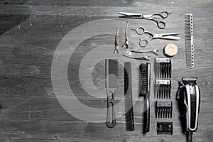Set of professional hairdresser tools on grey background. Wooden table in barbershop. Working tool of barber master