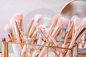 Set of professional makeup brushes in holder