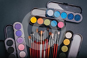 Set of professional makeup brushes and palette with color eye shadow