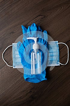 Set of protective eqipment agains corona covid viruses - chirurgical mask, gloves, glasses and bottle with alcohol gel or liquid photo