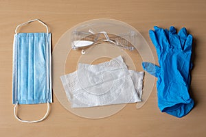 Set of protective eqipment agains viruses - wet wipe, chirurgical mask, gloves and glasses photo