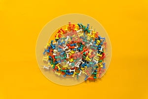 Set of push pins in different colors. Thumbtacks. Top view. on Yellow background