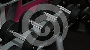 Set, a rack of dumbbells of different sizen for training, close-up.
