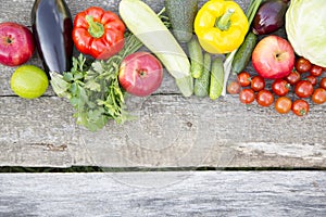 Set of raw organic fruits and vegetables on dark wooden background. Copy space. Top view. From above.