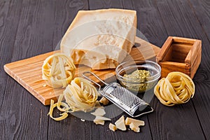 Set of raw pasta and addons on wooden table. Studio picture