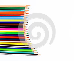 Set of realistic pencil crayons arranged in a waved pattern on a white background