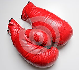 A set of red boxing gloves on a white background