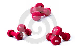 Set of red dumbbells isolated on white background. 3 pairs of red neoprene dumbbells. Home gym equipment for exercise at home.