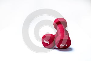 Set of red dumbbells isolated on white background. A pair of red neoprene dumbbells. Home gym equipment for exercise at home.