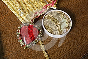 Set of red plastic decorative heart and yellow beads