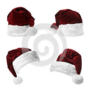 Set of red Santa Claus hats on white