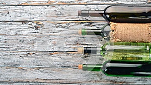 Set of red and white wine in bottles and glasses. Grape. On a white wooden background. Free space for text.