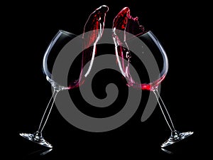 Set of red wine glasses with splashes isolated on black