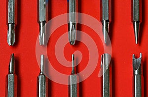 Set of replaceable screwdrivers on red background