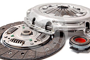 Set of replacement automotive clutch isolated on white background. Disc and clutch basket with release bearing.