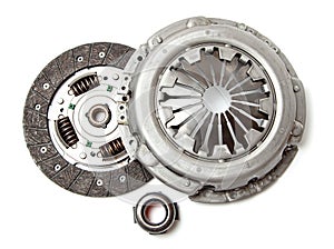 Set of replacement automotive clutch isolated on white background. Disc and clutch basket with release bearing.