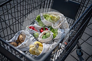 Set of reusable and zero waste cotton shopping bags for food in cart