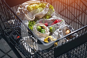 Set of reusable and zero waste cotton shopping bags for food in cart