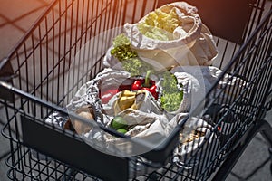 Set of reusable and zero waste cotton shopping bags for food in cart