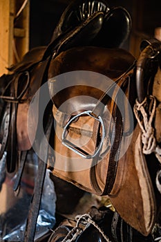 A set of riding equipment in a wooden stable at the equestrian club