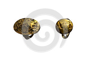 Set of 2 rings isolated on white background. The so-called ring of Minos and a golden ring depicting a griffin and a female figure photo