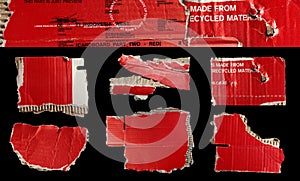 Set of ripped red cardboard pieces isolated on black background