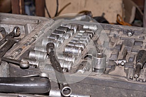 Set of round mechanic tools in the box. Car mechanic concept in the old mechanic workshop