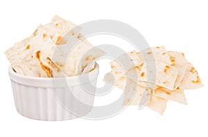 Set of ruddy pieces tortillas as heap and in ceramics bowl isolated on white background.