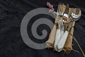 A set of Rustic vintage set of cutlery knife, spoon, fork on black background