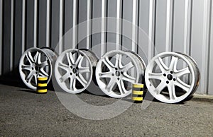 Set Of Rusty Damaged Alloy Wheel Rims In Garage