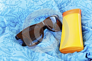 Set safety of the beach. Sunglasses and protective cream. The re