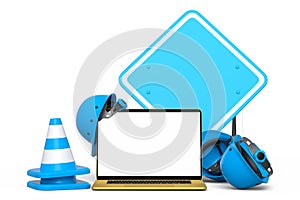 Set of safety helmet or hard hat, road traffic cones and sign near laptop