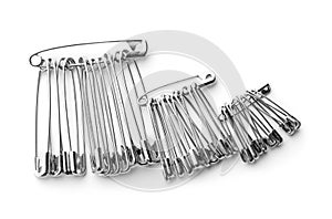 Set of safety pins on white background