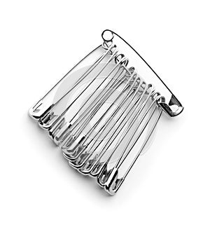 Set of safety pins on white background