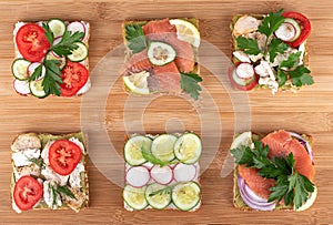 Set of sandwiches on a wooden background