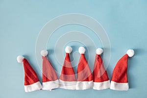 Set of Santa Claus or gnomes hats on a light blue background. Christmas or New Year concept. Minimalism. Copy Space