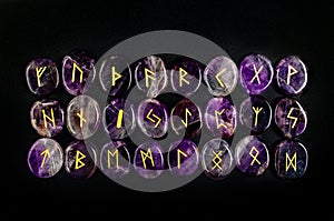 Set of Scandinavian runes made of natural amethyst. Elder Futhark