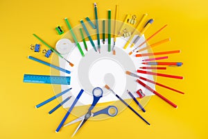 Set of school office supplies on yellow background