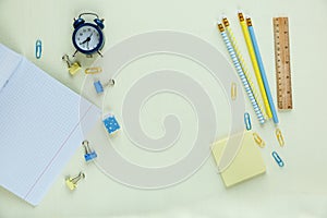 Set of school stationery back to school: pencils, clock, notepad, ruler on yellow background. education, lesson