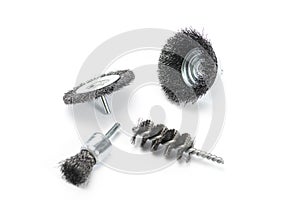 Set of scraping steel wire brushes for electric drill on white background