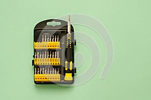 A set of screwdrivers for precision work on green background