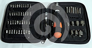 set of screwdrivers and various bits in a package