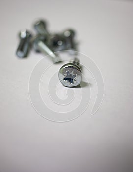 Set of screws close up. Macro photo of screws on a white background. Building abstraction. Industrial background. Macro photo